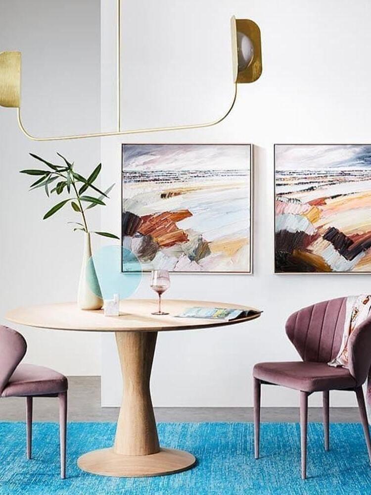 Gold-coloured leaf-like fixture above a round table