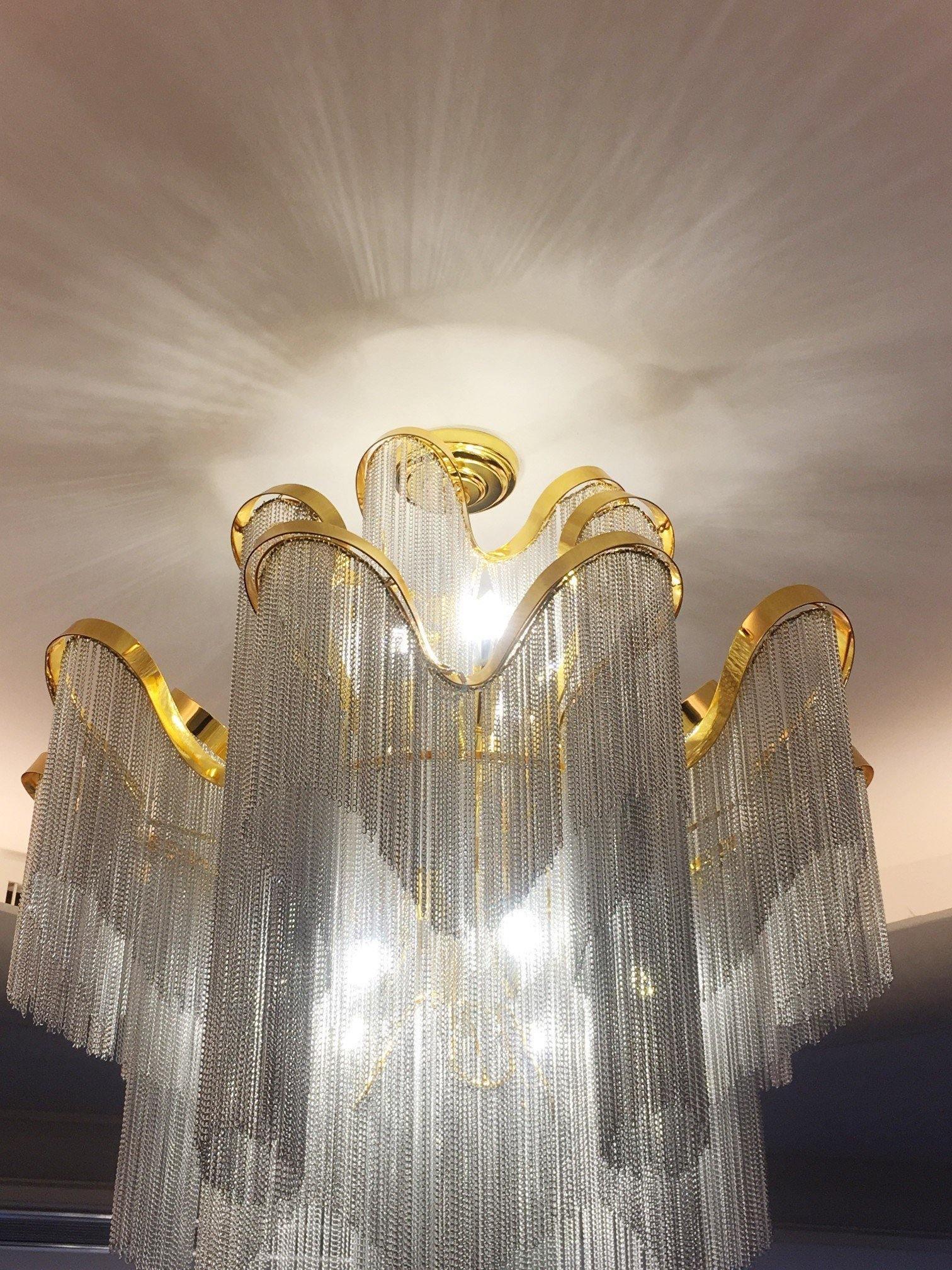 Gold-edged wavy rails and pale hanging chains