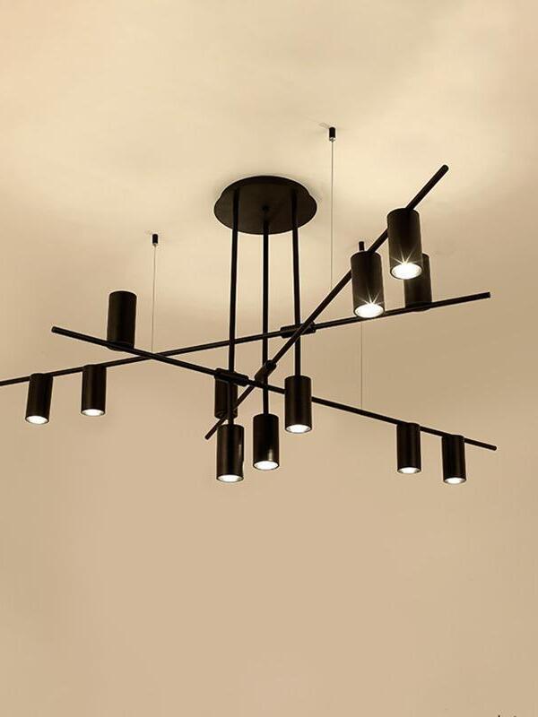 Black crossed-bar chandelier illuminated from below