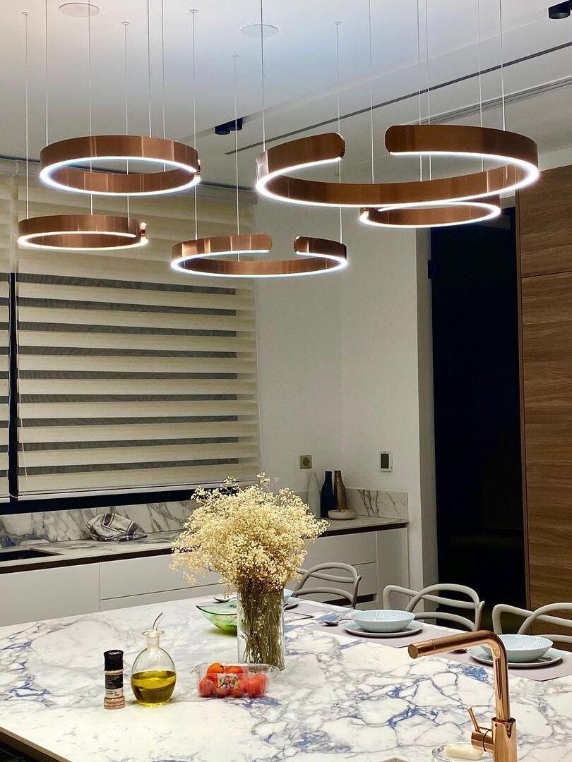 Grouped illuminated rings above a marble-patterned counter