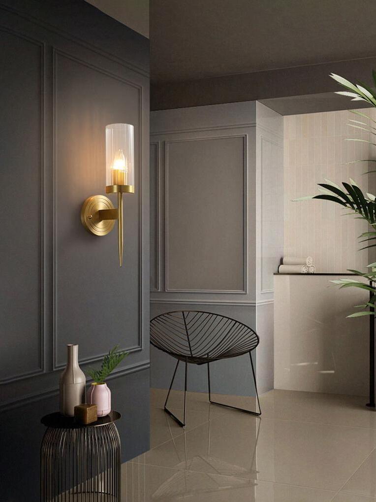 Single sconce on a dark panel near an entryway
