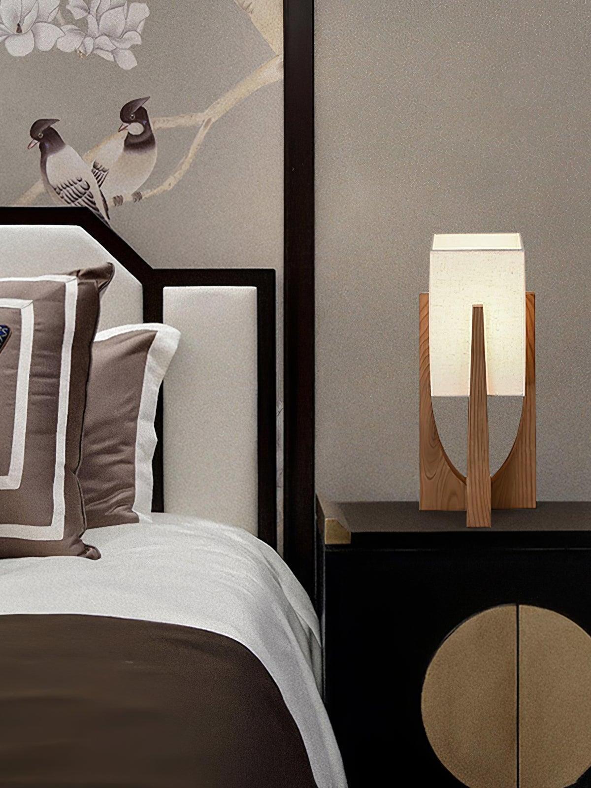 Short wood frame lamp on bedside table
