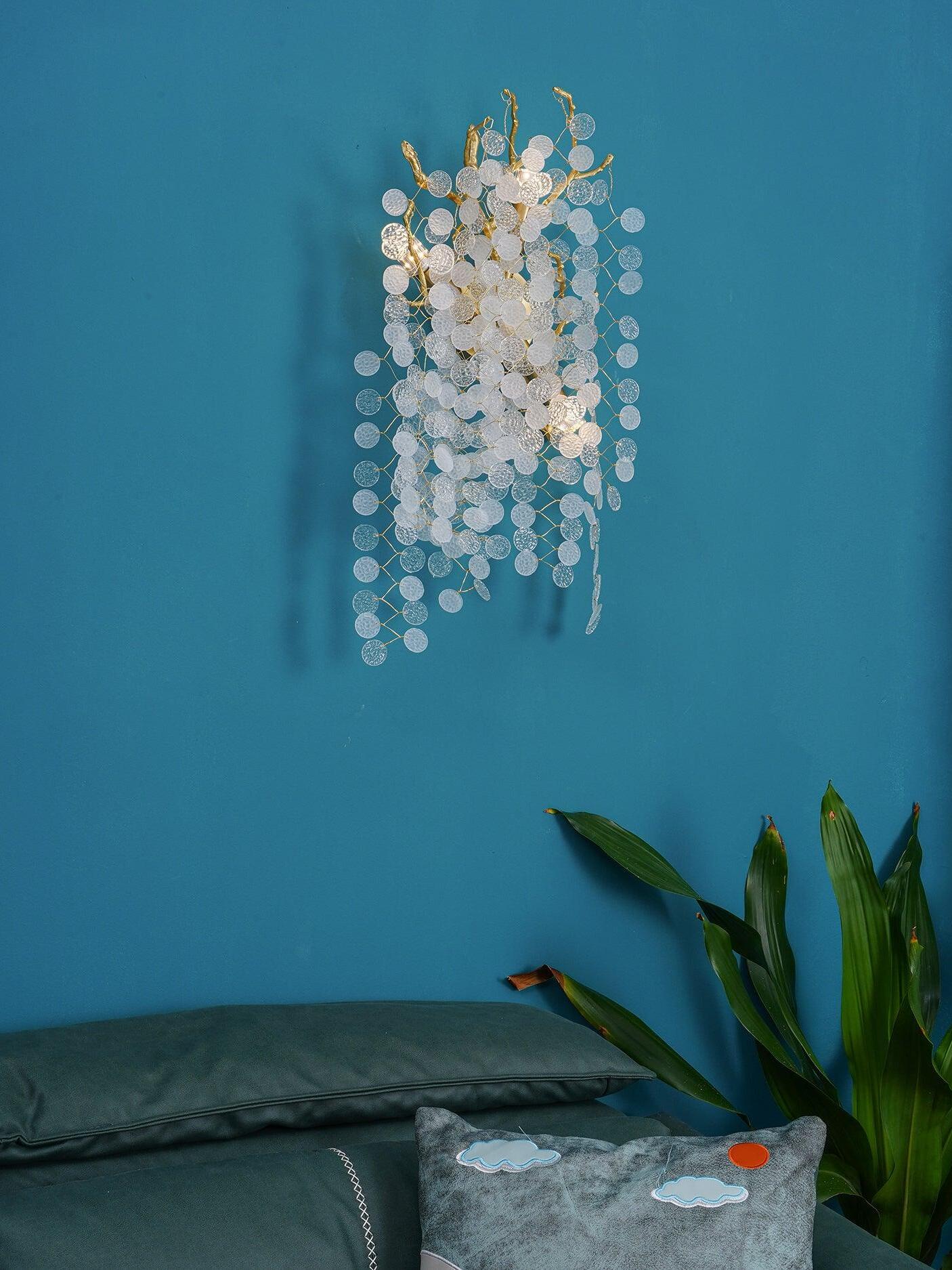 Clear hanging discs against a blue wall