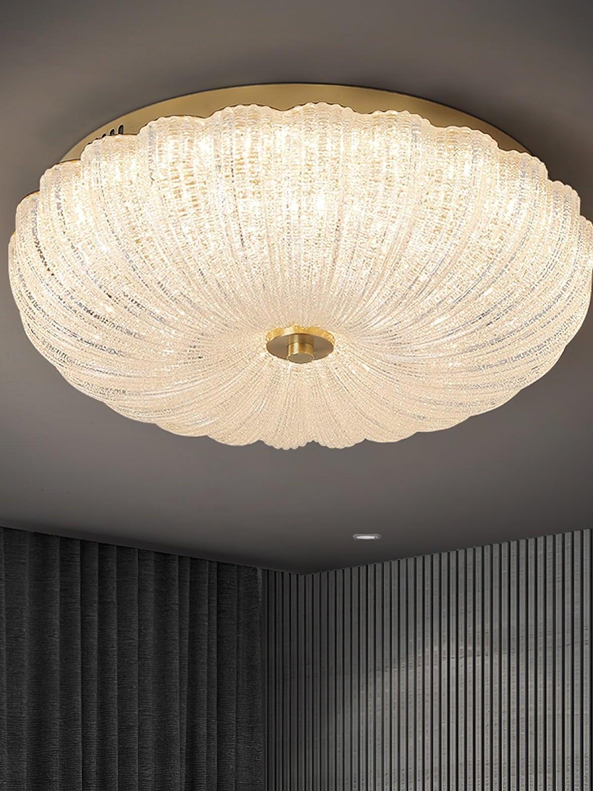 Glowing fluted glass ceiling bowl viewed from below above dark vertical wall slats