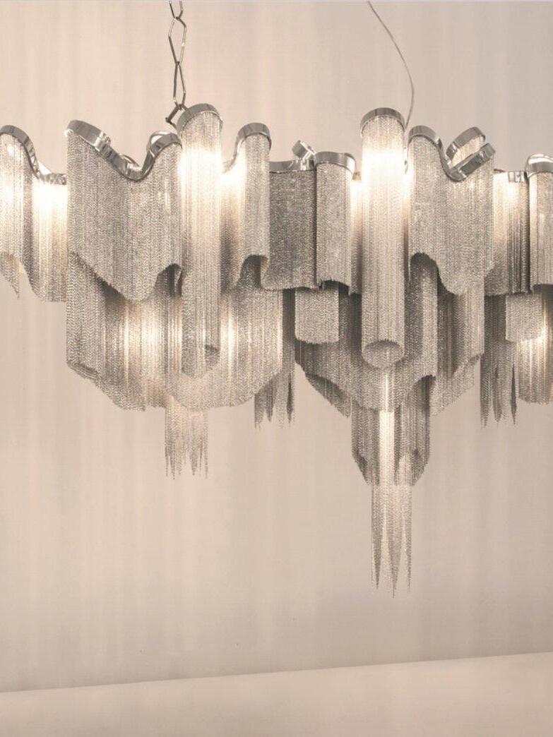 Elongated wavy chain fixture in warm light