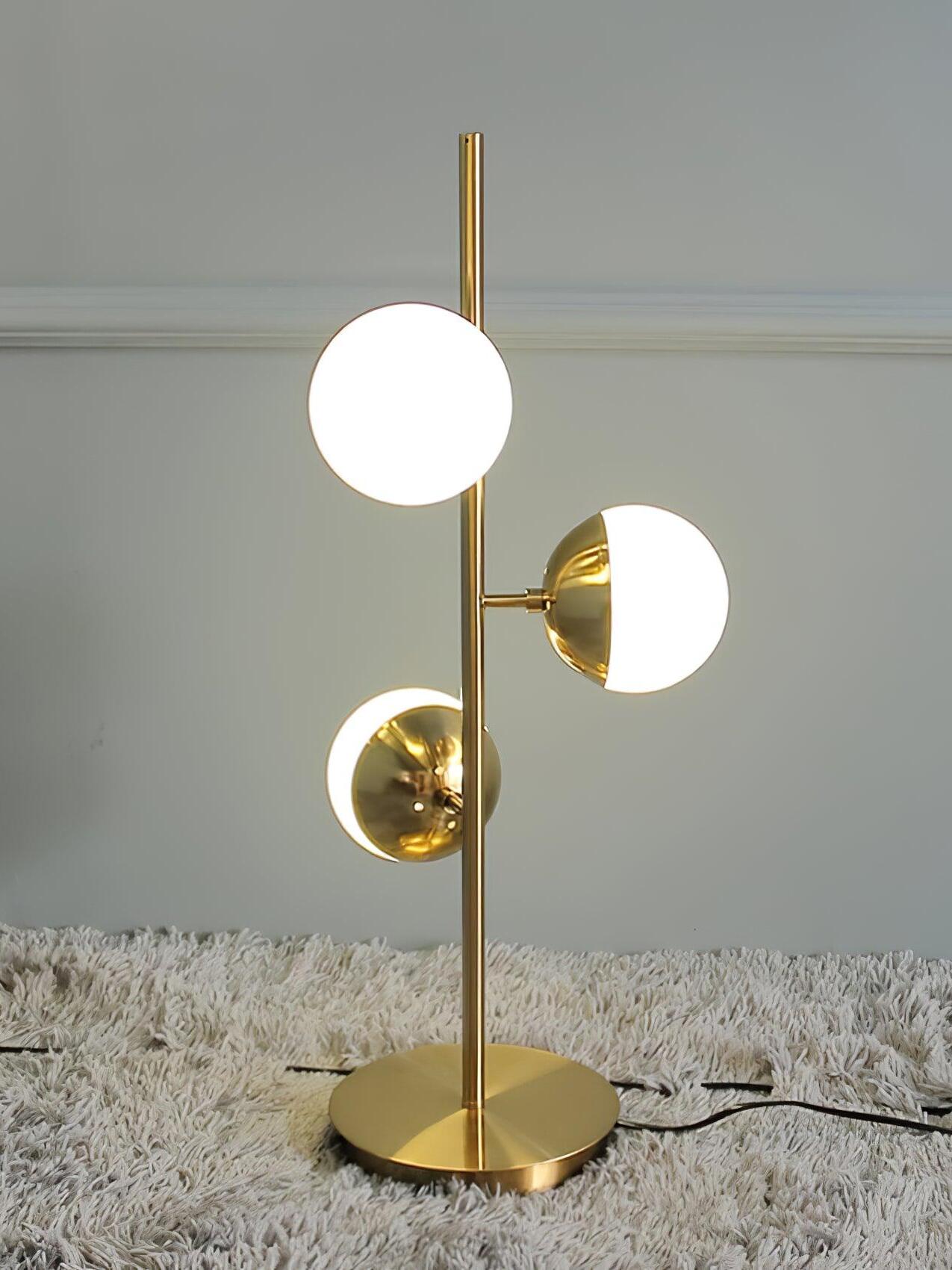 Short gold globe lamp on grey carpet