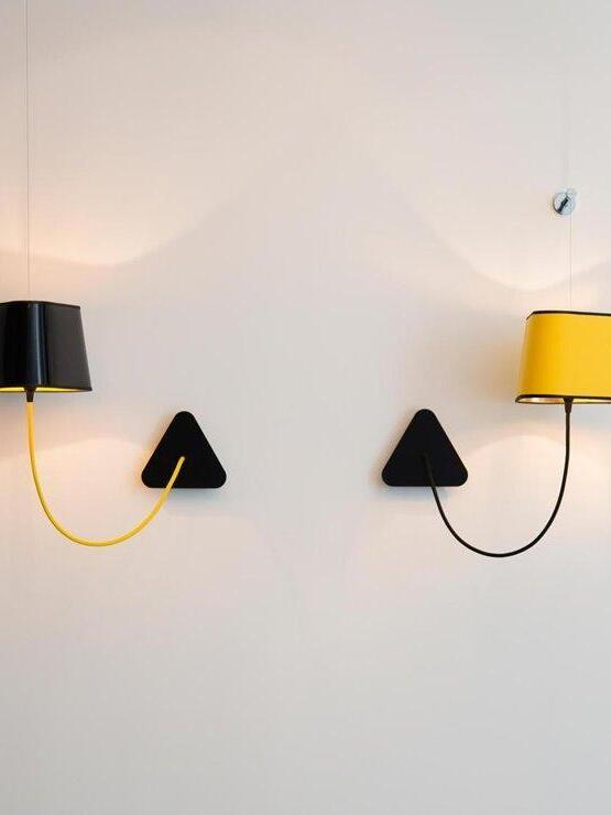 Two wall arrangements with black and yellow shades