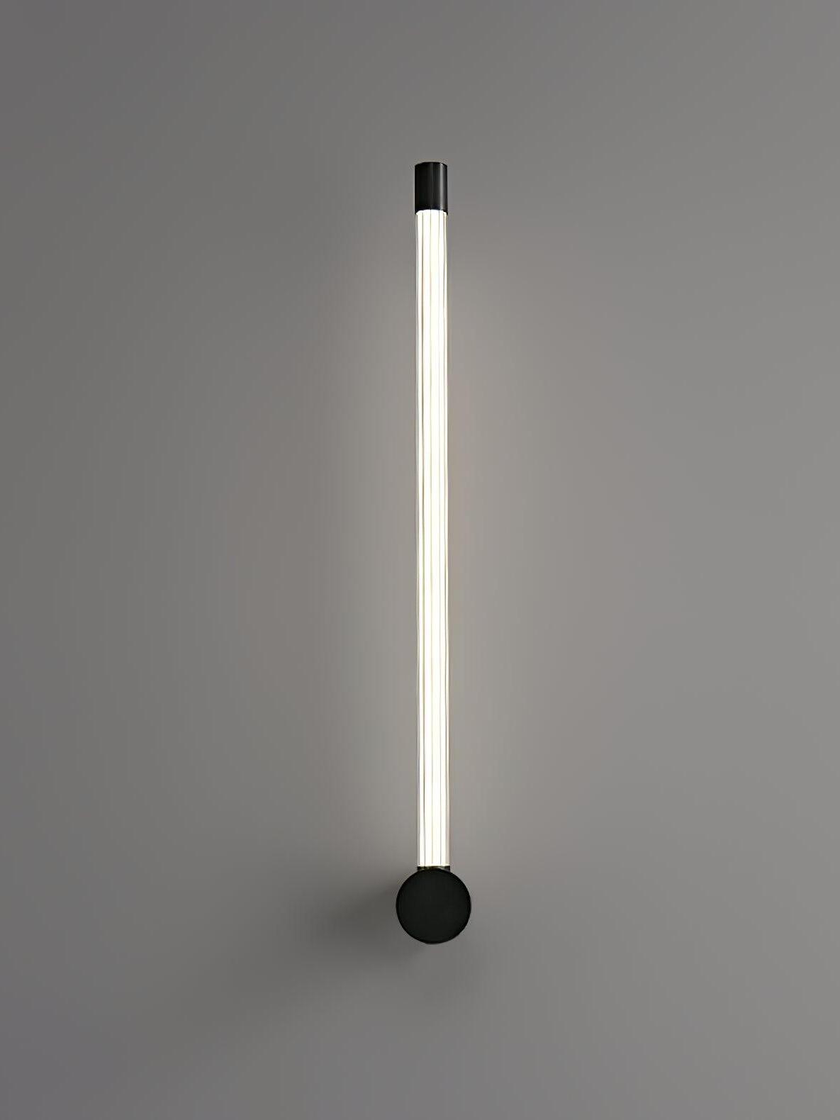 Black single upward ribbed tube wall light with a round mount and capped upper end