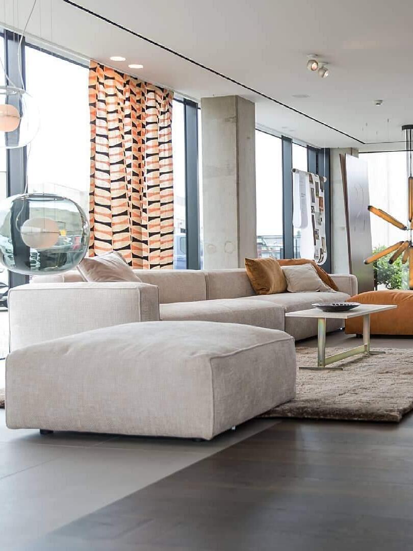 Glass pendant beside a pale sectional sofa