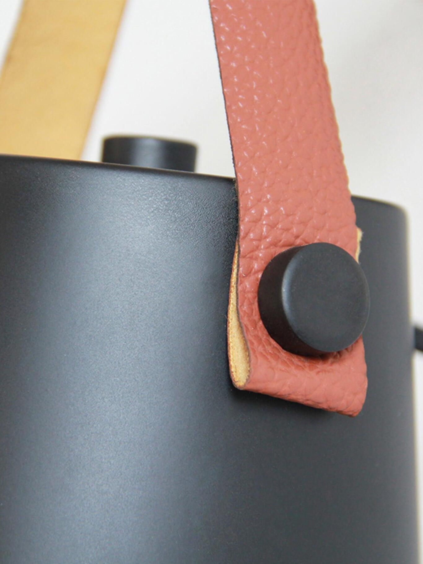 Close-up of brown textured strap and dark shade fastener