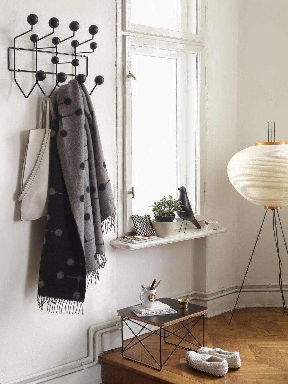 Partially visible paper floor lamp near window