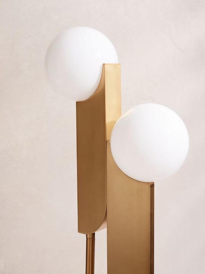 Two white globes and gold-colour blades shown close together, with narrow support rods beneath