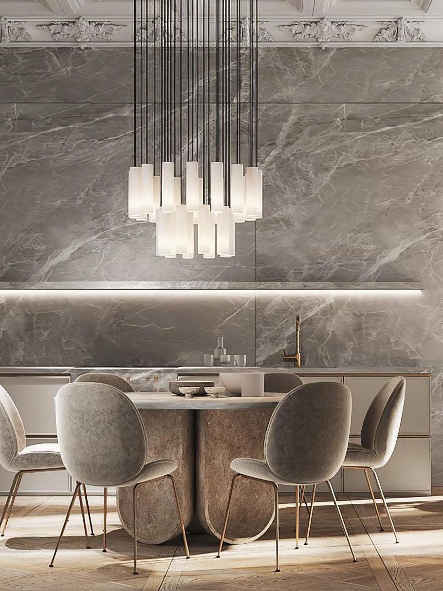 A Silo cylinder cluster above a round dining table with upholstered chairs and a veined wall