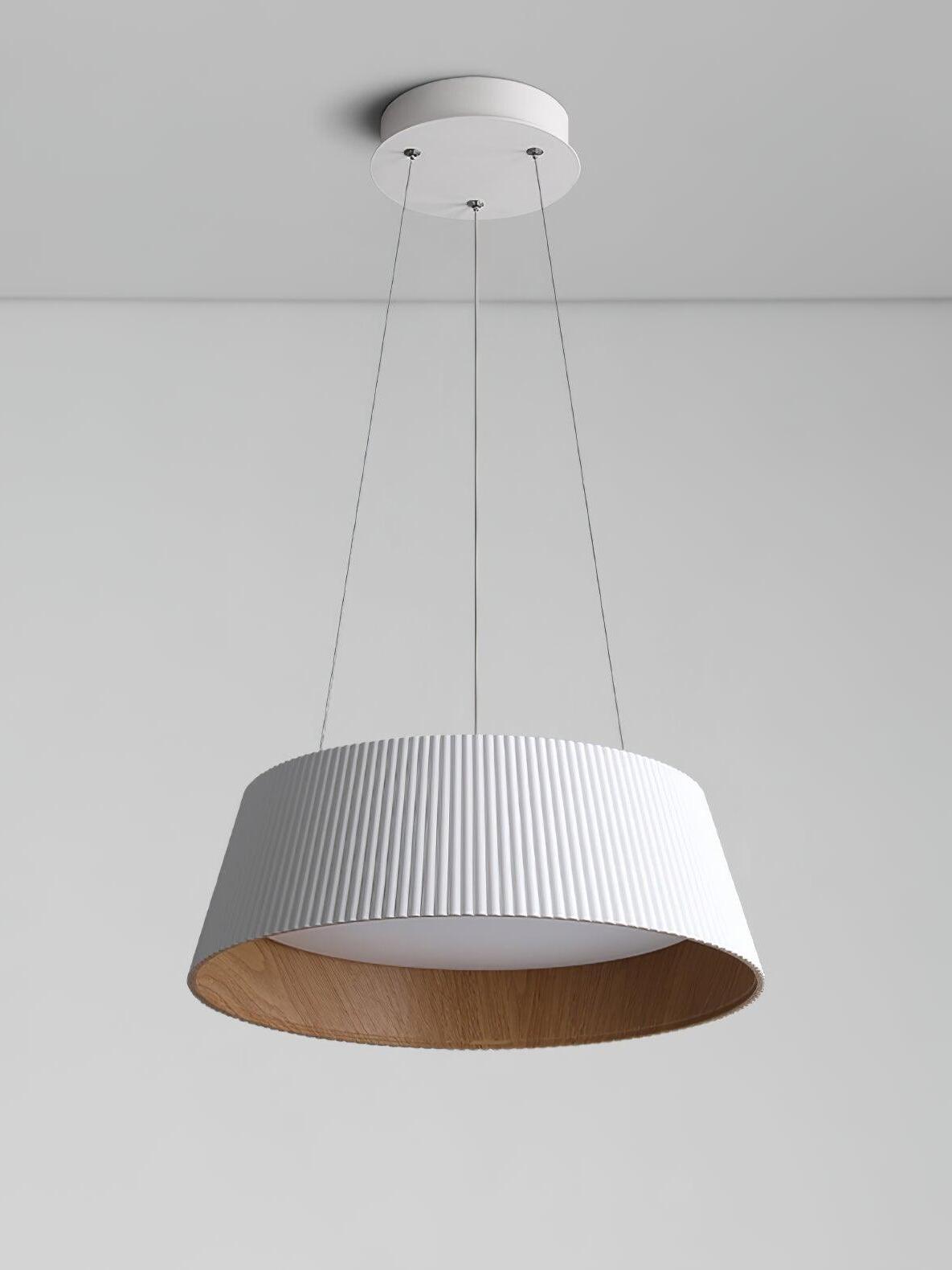 Whole White ribbed pendant against gray, showing round canopy, three lines, recessed white diffuser and tan inner wall