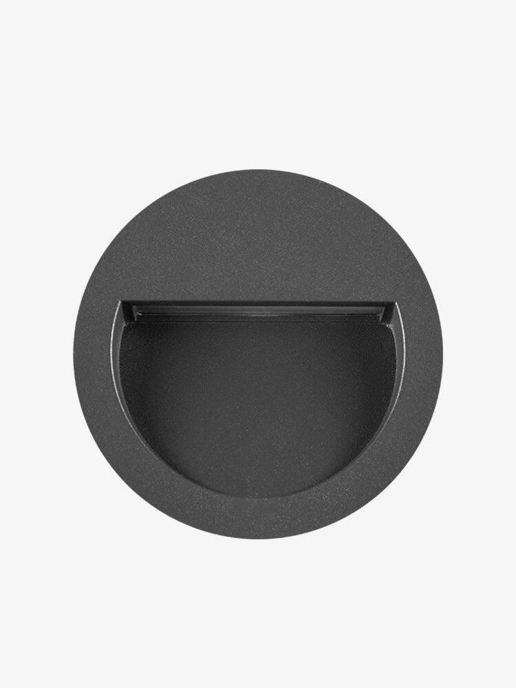 Black round light with recessed half-moon opening