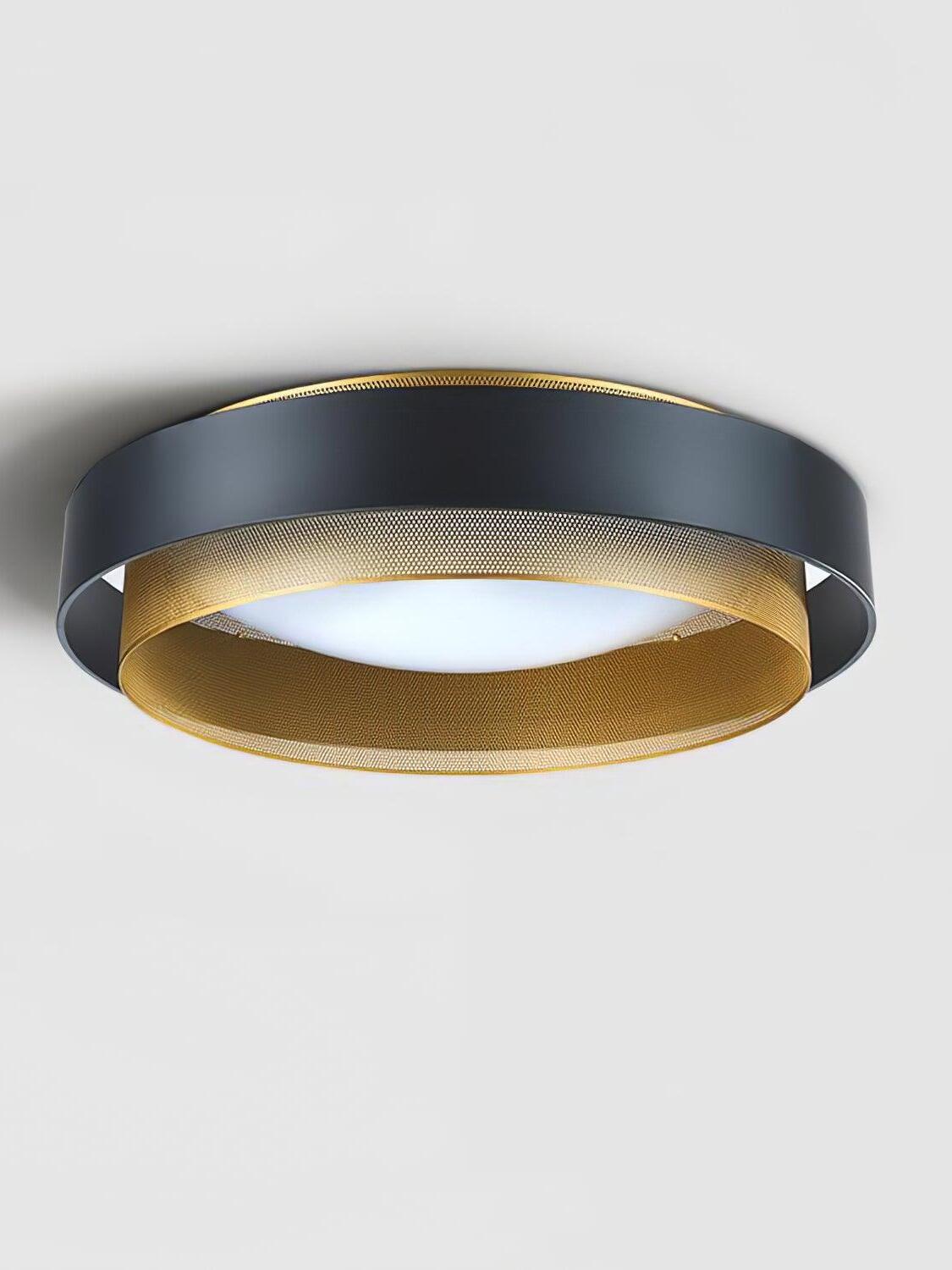 Angled view of the black Nolan outer band, gold ring and pale circular diffuser