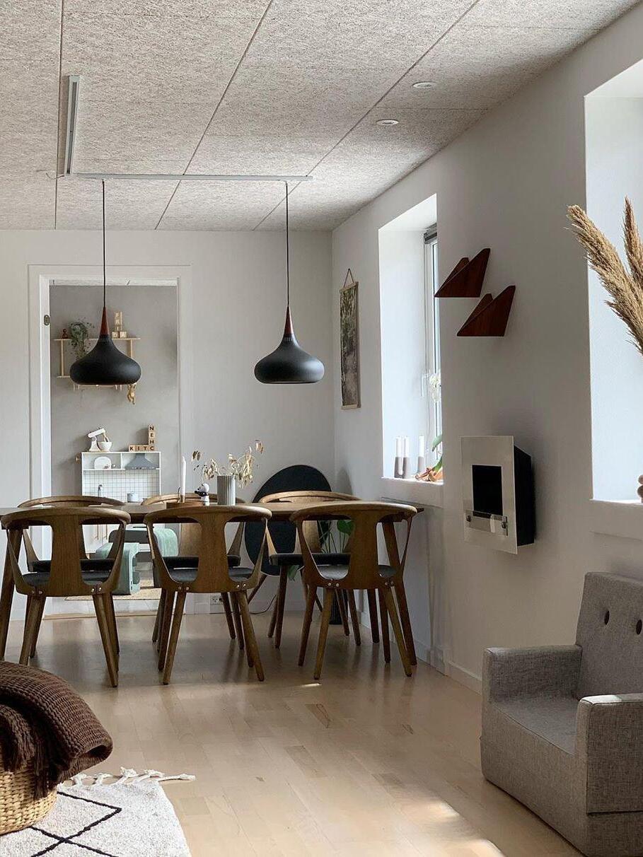 Separate dark pendants in a long dining room