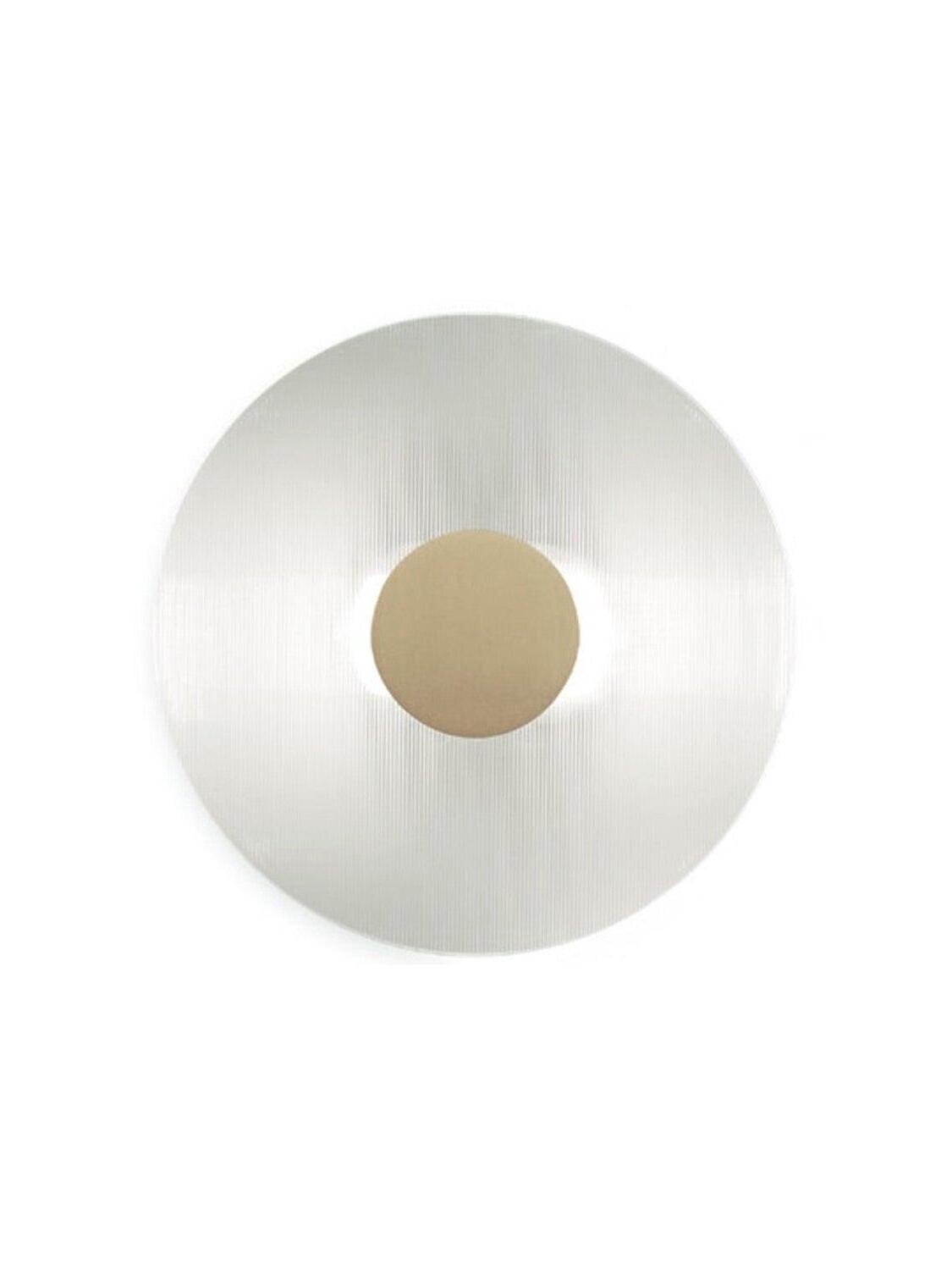 Isolated round Button wall light with clear ribbed glass and a circular gold-coloured centre