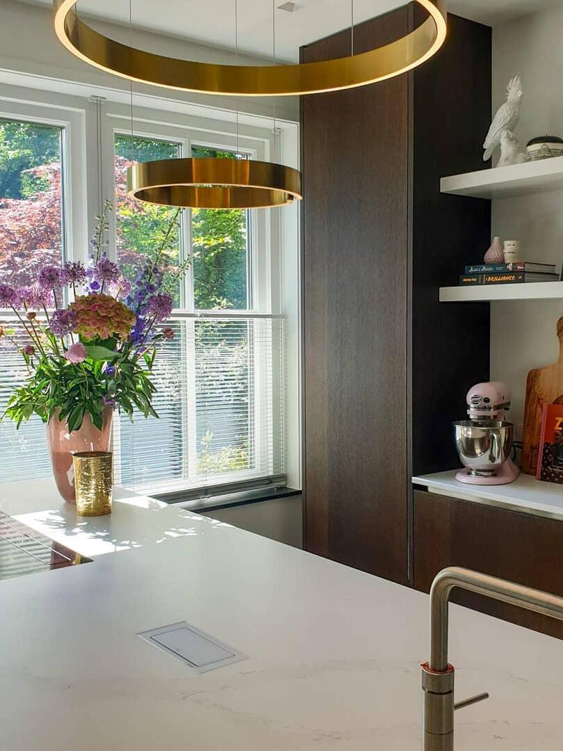 Two gold-coloured rings beside a bright window