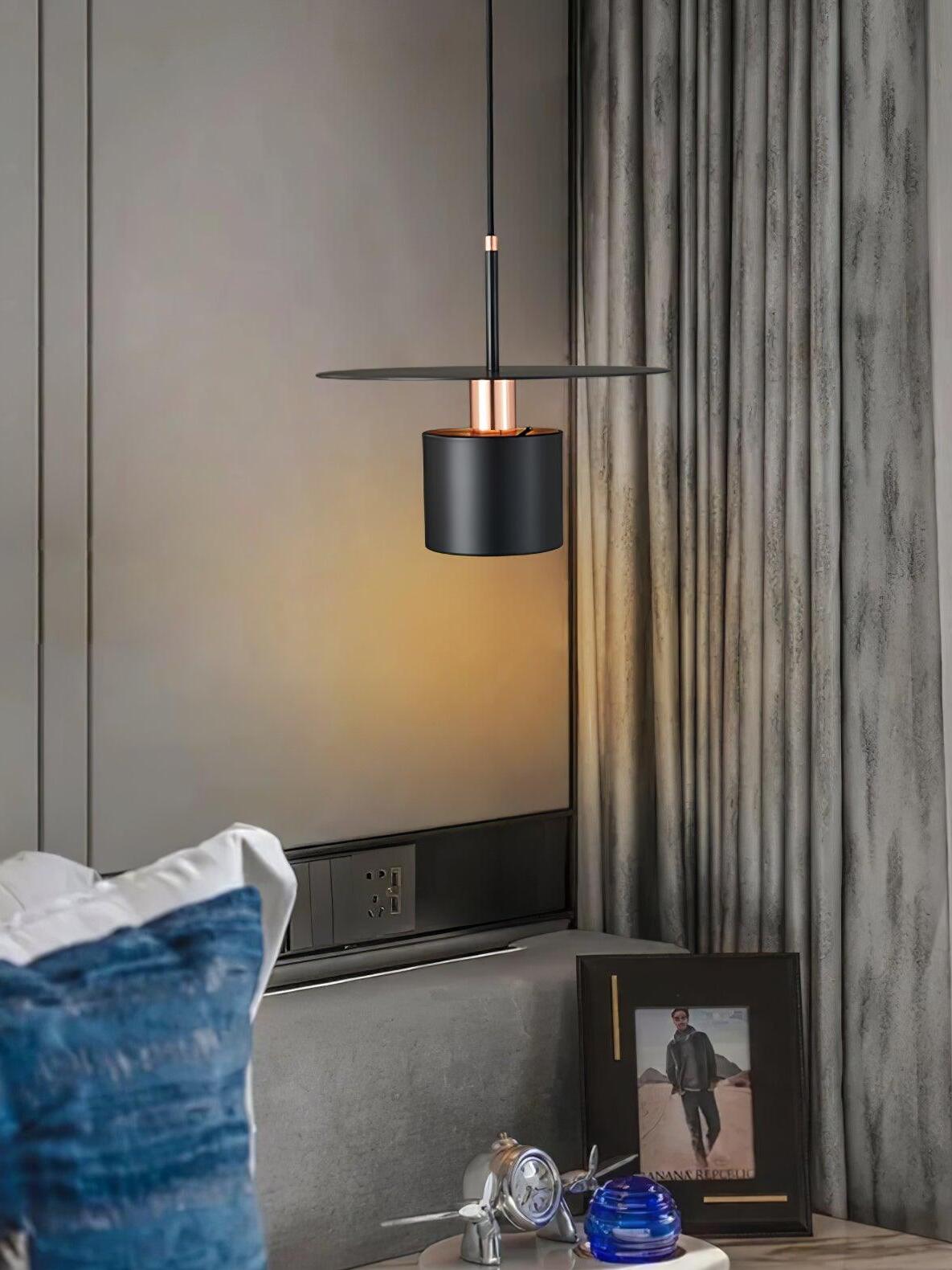 Black metal disc pendant near blue sofa