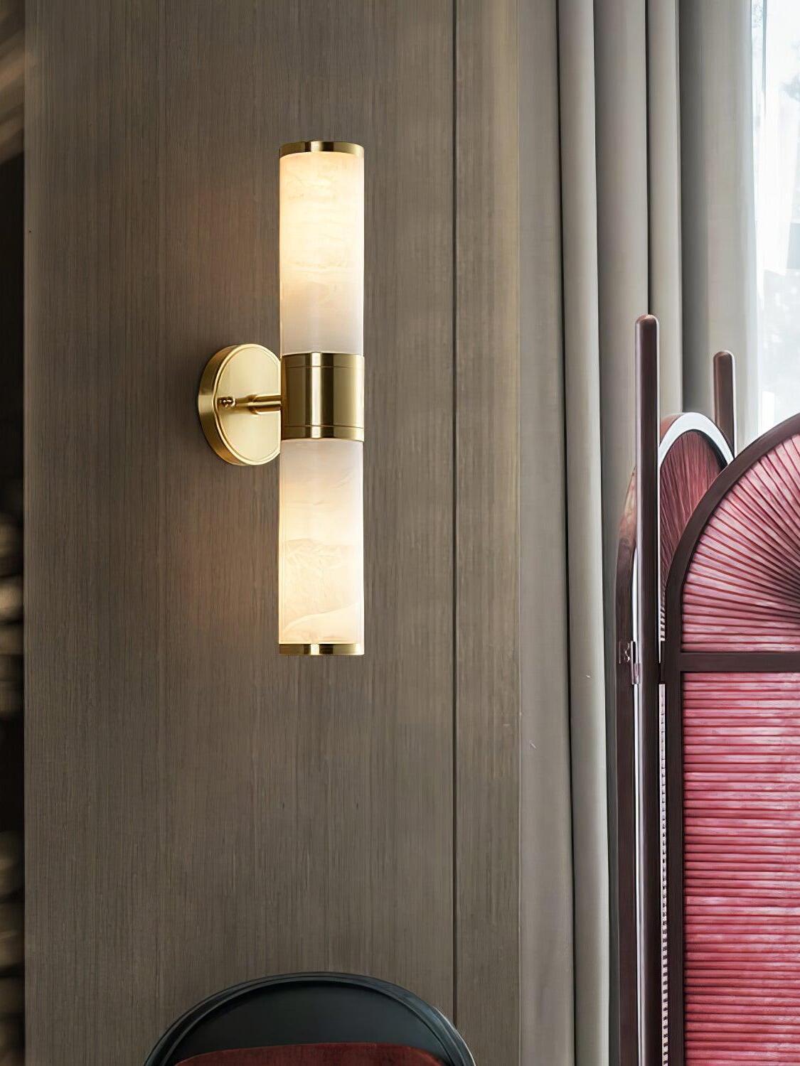 Tall brass wall light with stone above and below mount