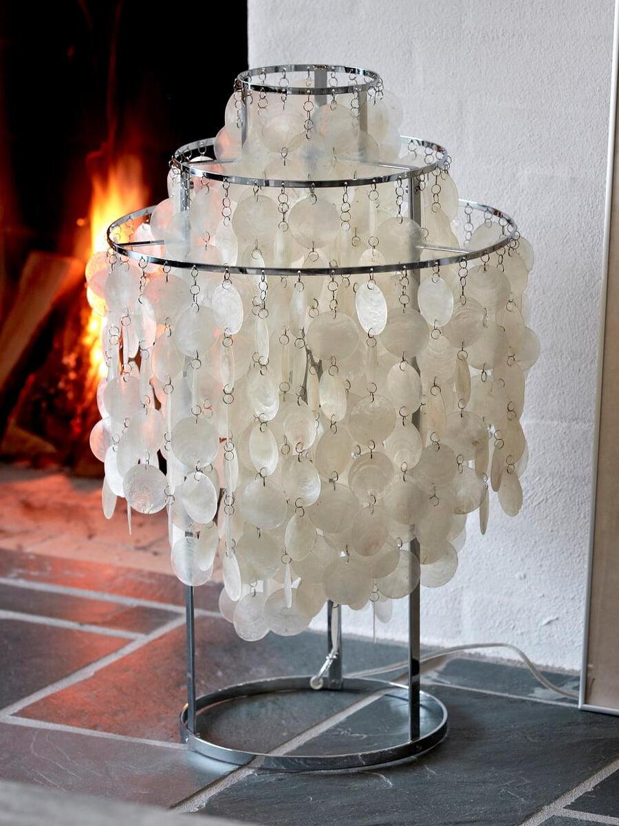 Shell table lamp with round base on hearth tiles