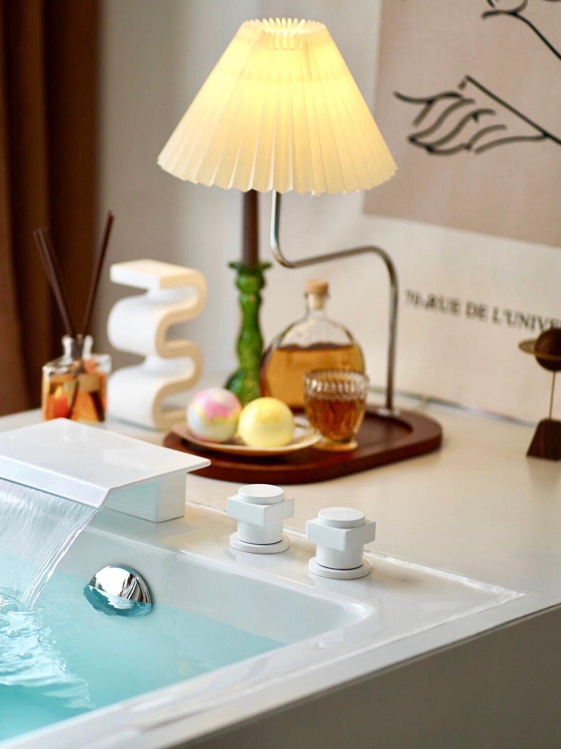 Pleated lamp photographed beside a washbasin