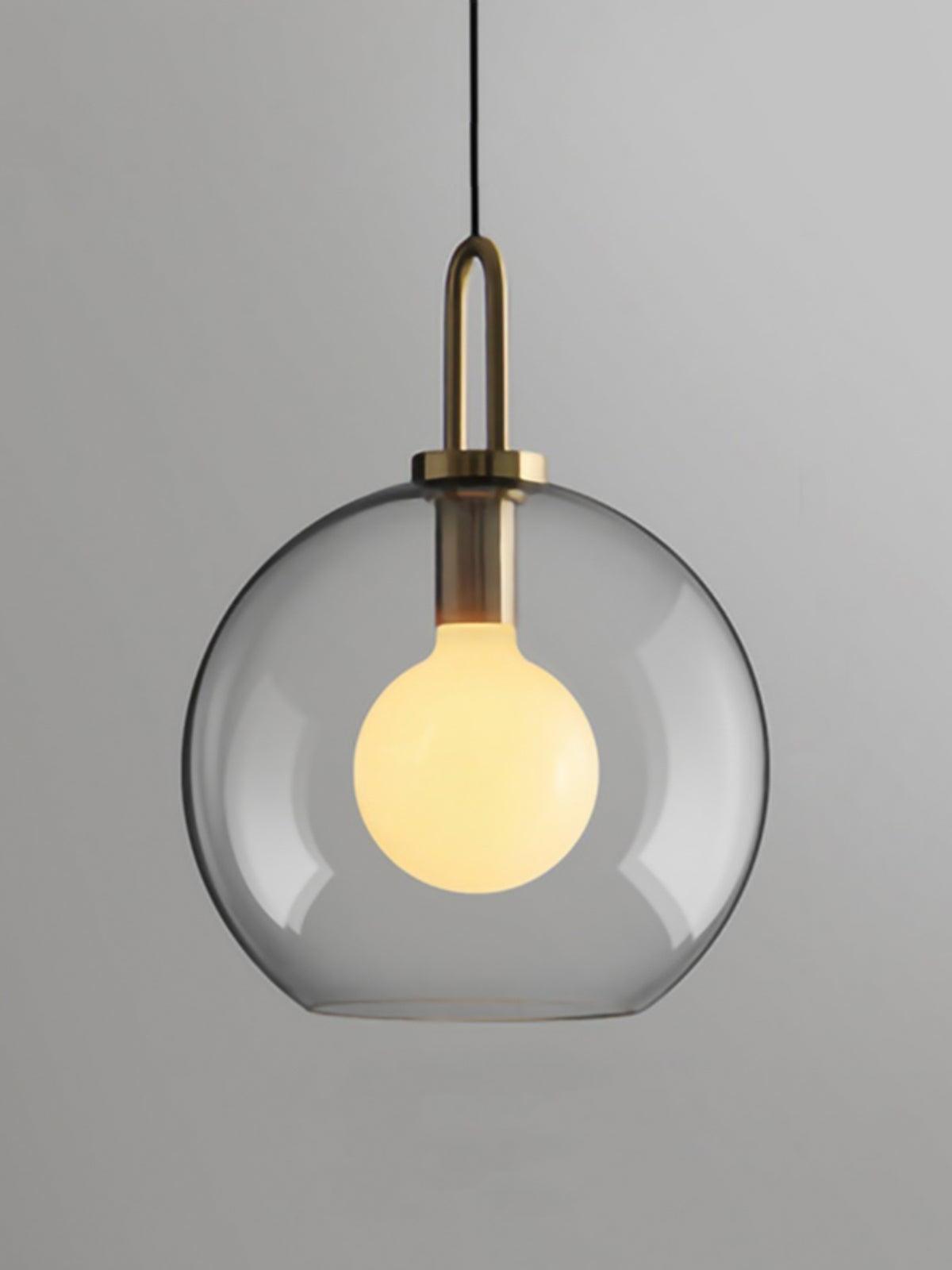 Large clear glass globe pendant surrounding a visible round bulb