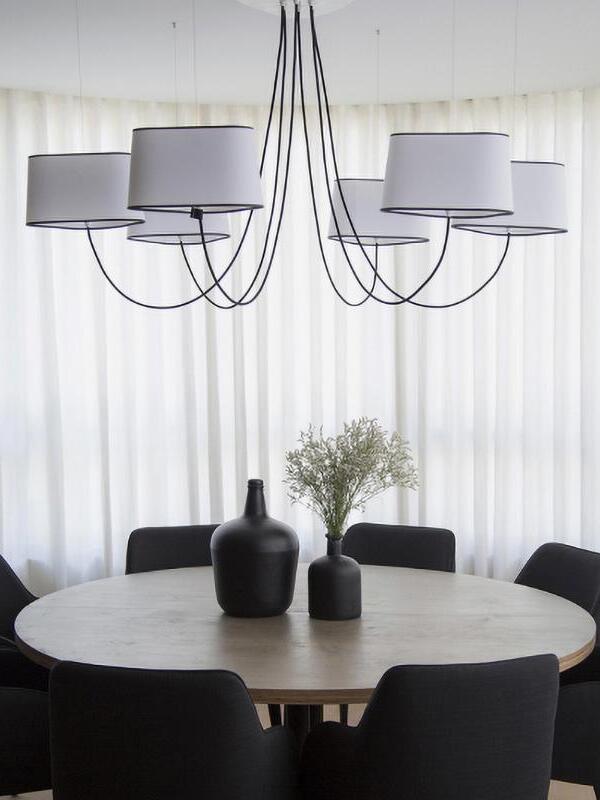 Gallery chandelier with several grey shades above a table