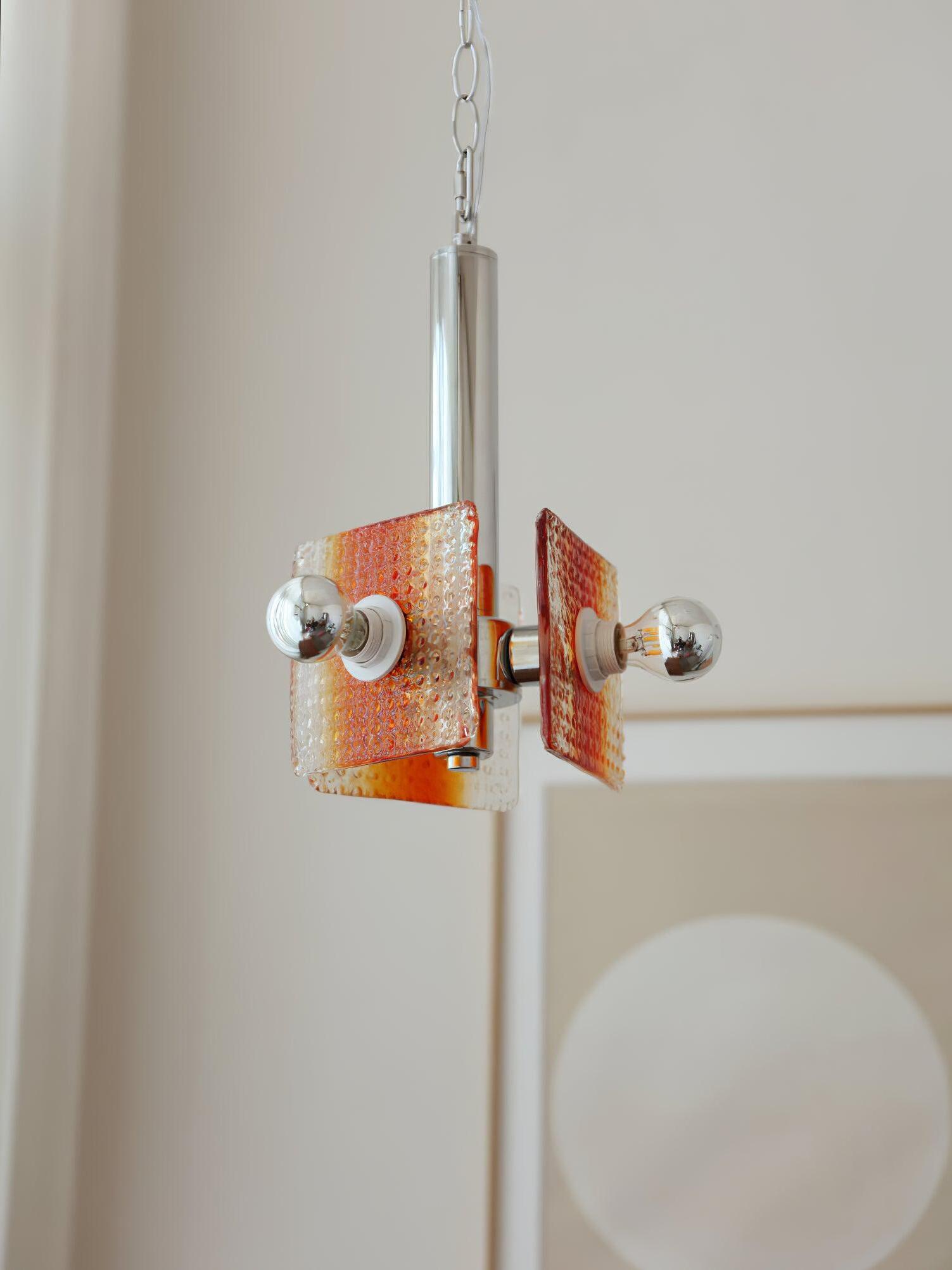 Alohi pendant with exposed round bulbs beside textured orange glass