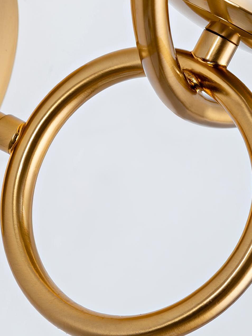Close view of joined gold loops beneath globe