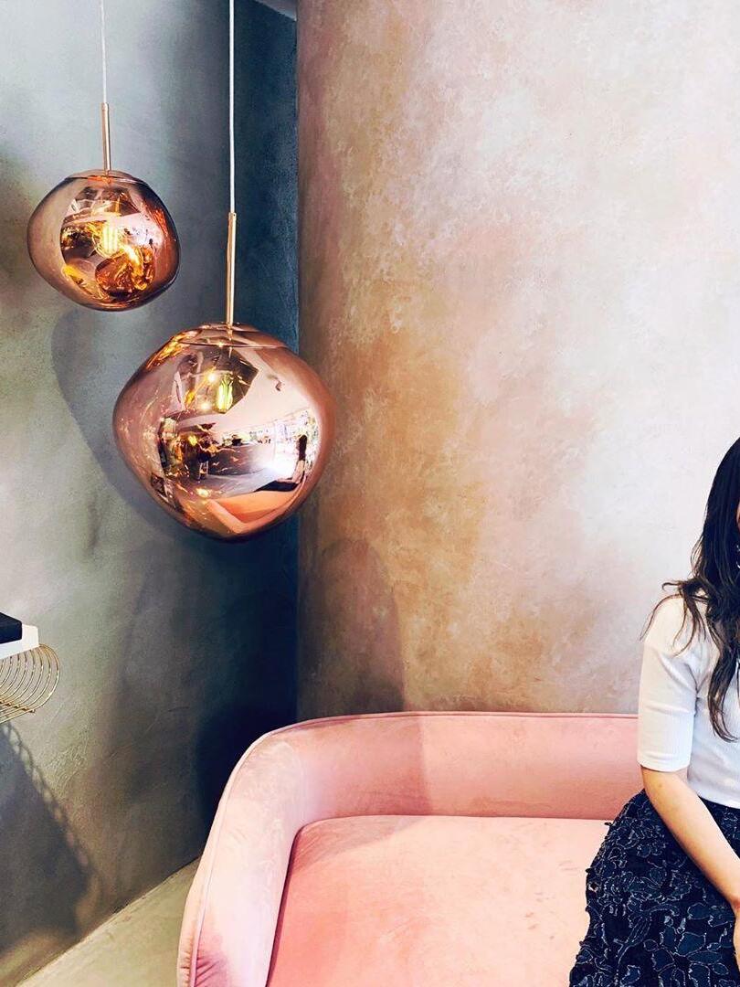 Two copper-toned rounded shades near a sofa
