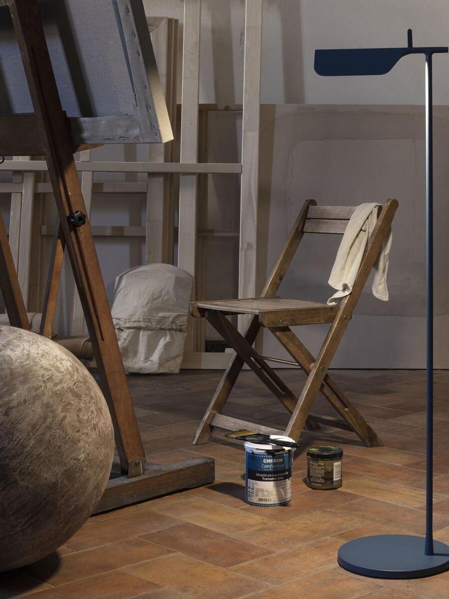 Blue floor lamp beside a wooden chair