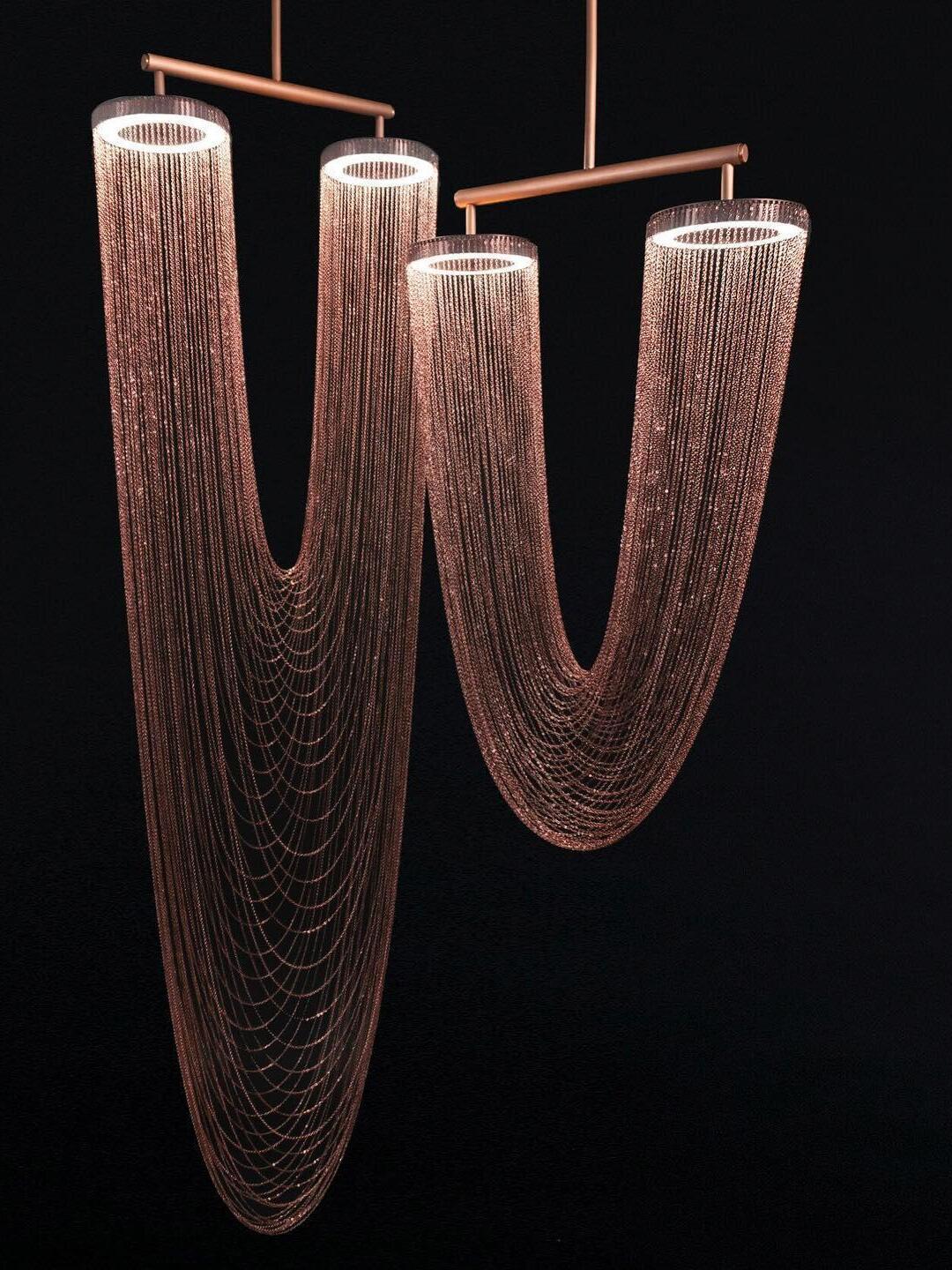 Two U-shaped chain fixtures hanging side by side