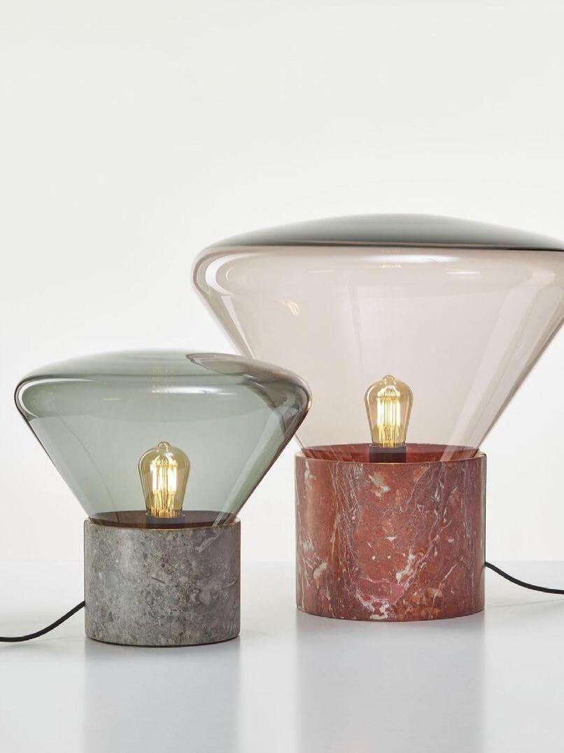 Two glass lamps with grey and red marbled-looking cylindrical bases