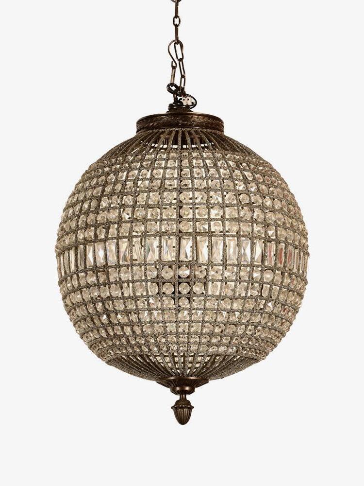 Unlit spherical crystal fixture with a short chain, dark gold-tone ornaments and rectangular middle band