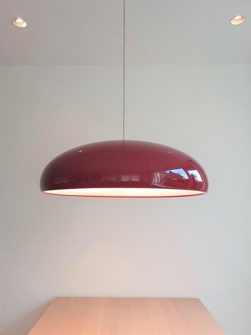Red dome above a light wooden table