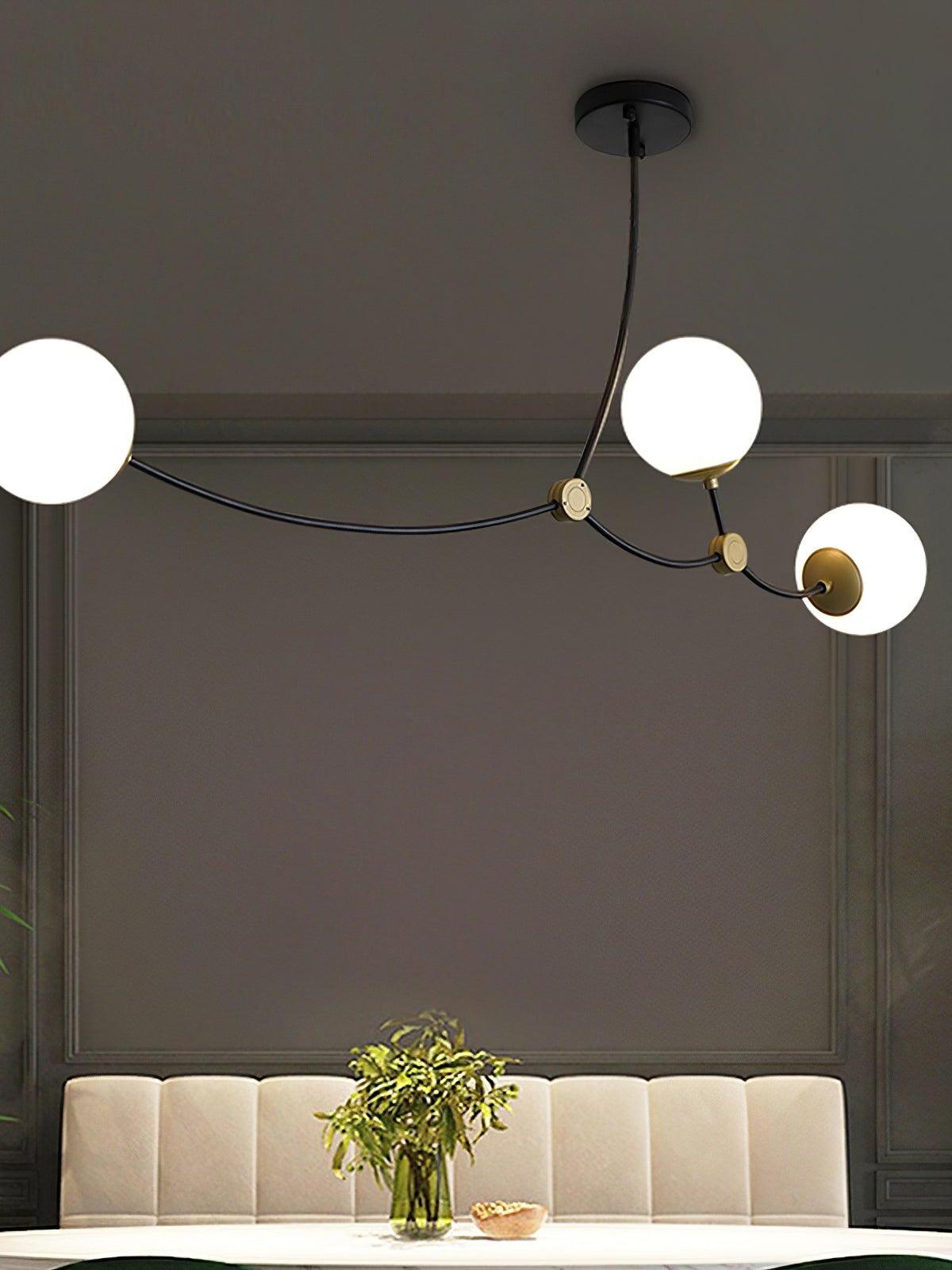Three white globes above upholstered dining seating