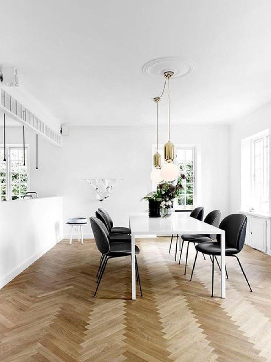 Globe pendant over a dining table in a bright room