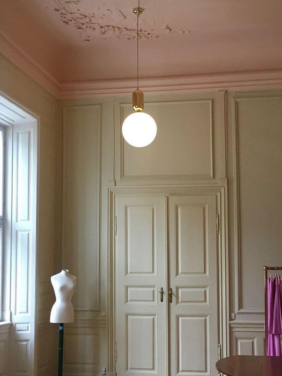 Single globe pendant in front of a panelled doorway