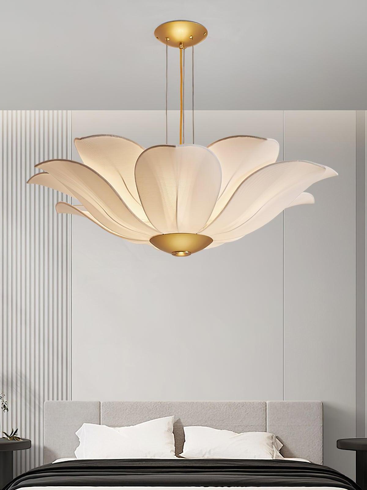 White flower chandelier above a bed
