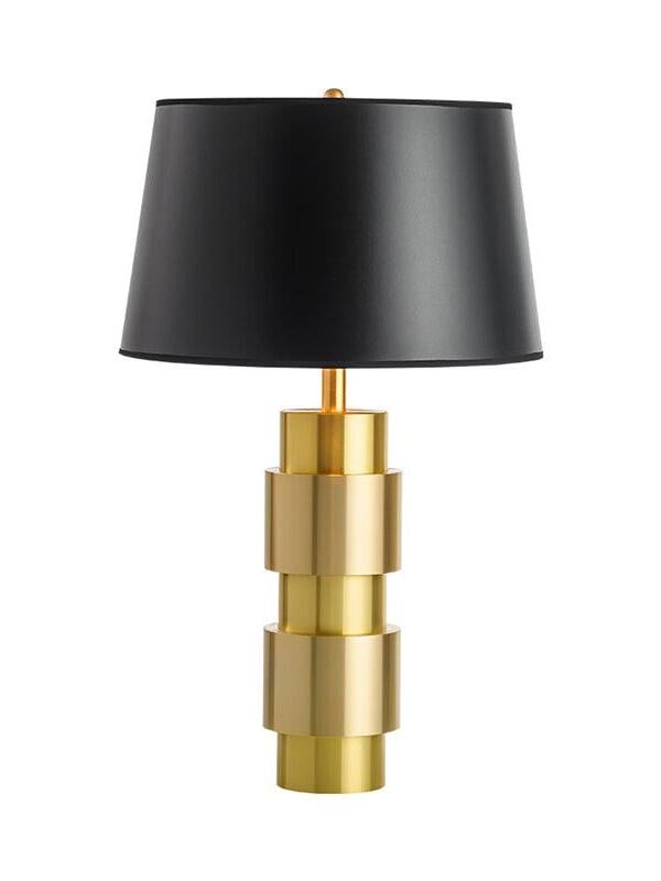 Jean lamp with a gently tapered black shade and alternating-width gold-tone cylinders on a white background