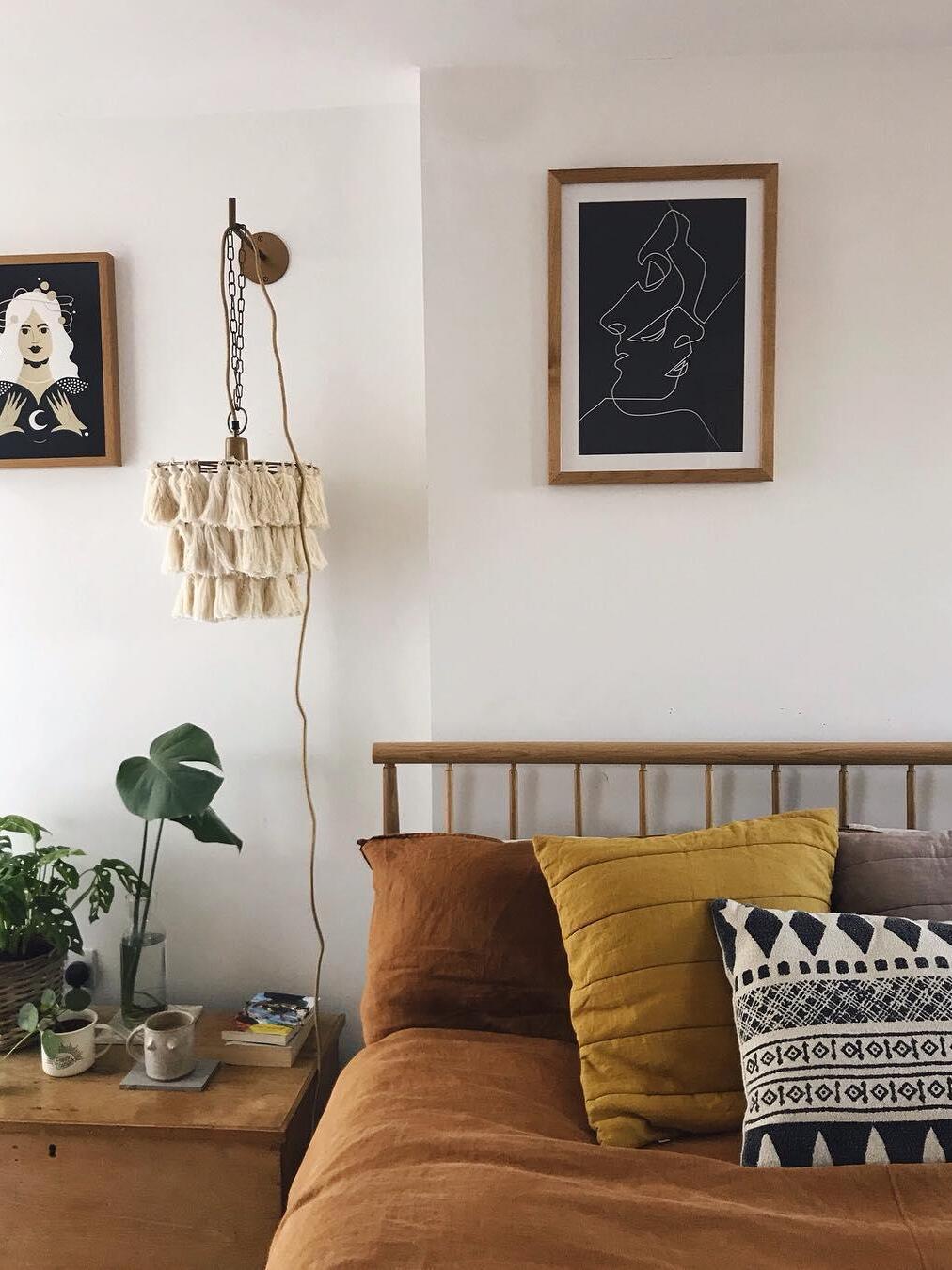 Cream tassel fixture beside a wooden bed