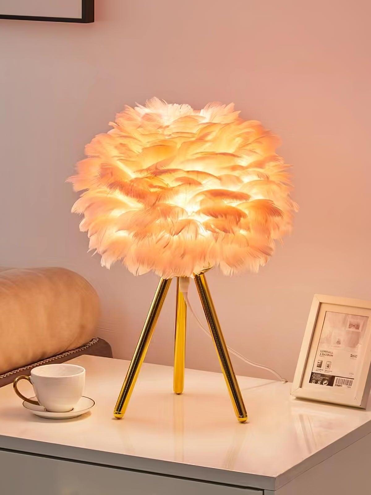 Warm glowing feather lamp beside cup on table
