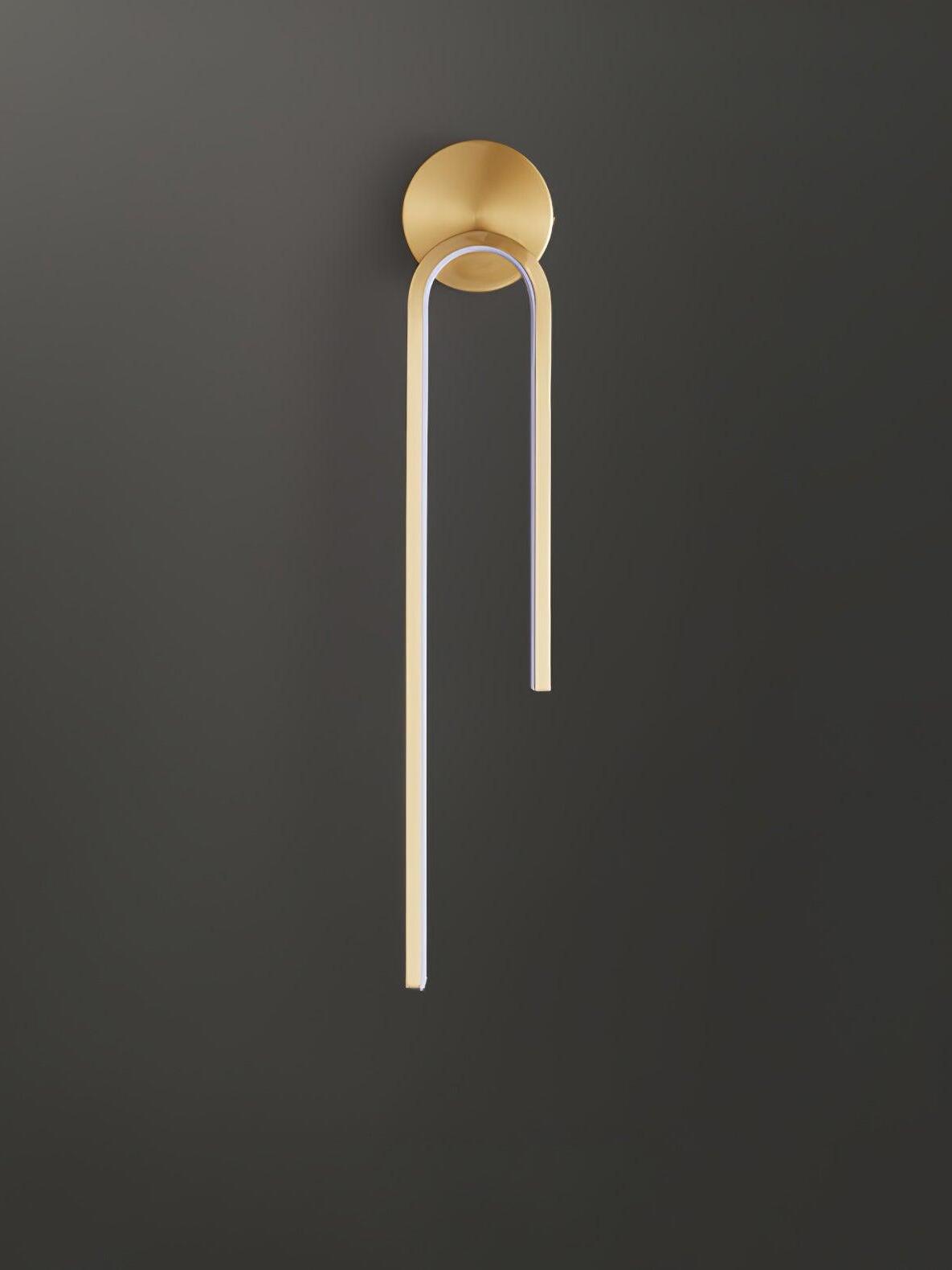 Gold-tone arch with an unlit white inner diffuser, long left arm and round backplate on dark gray