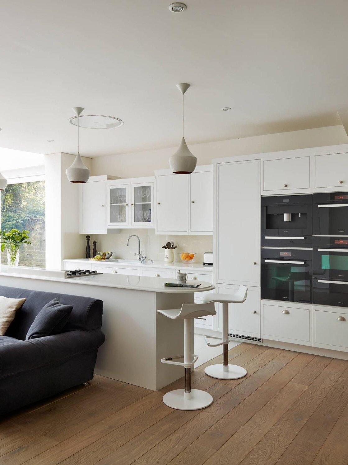White pendants above a pale kitchen island