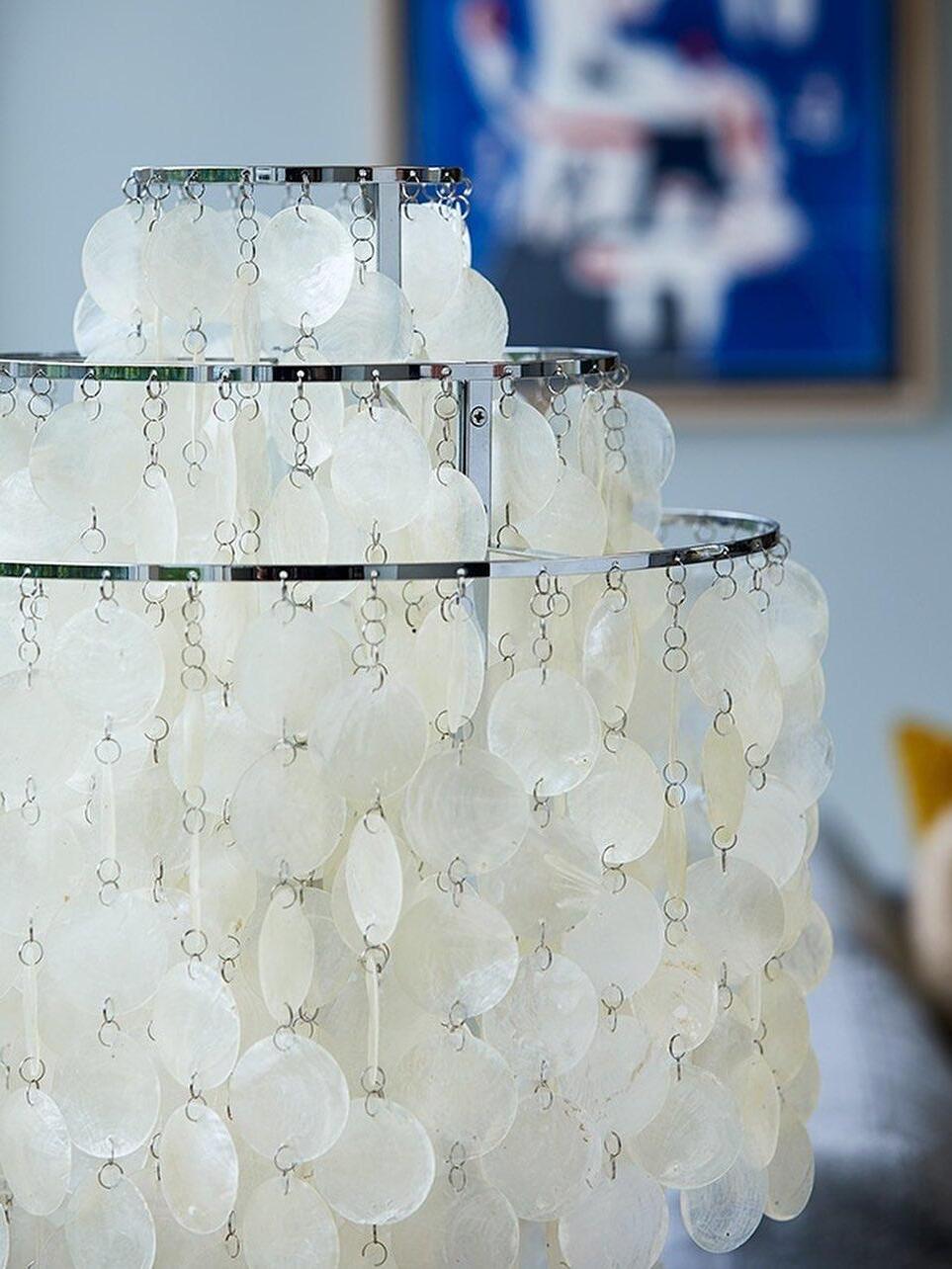 Stepped chrome-tone rings with linked pale shell discs