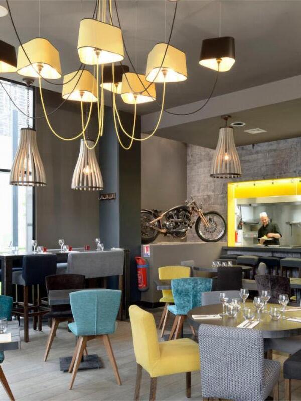 Gallery chandelier over a dining-room arrangement