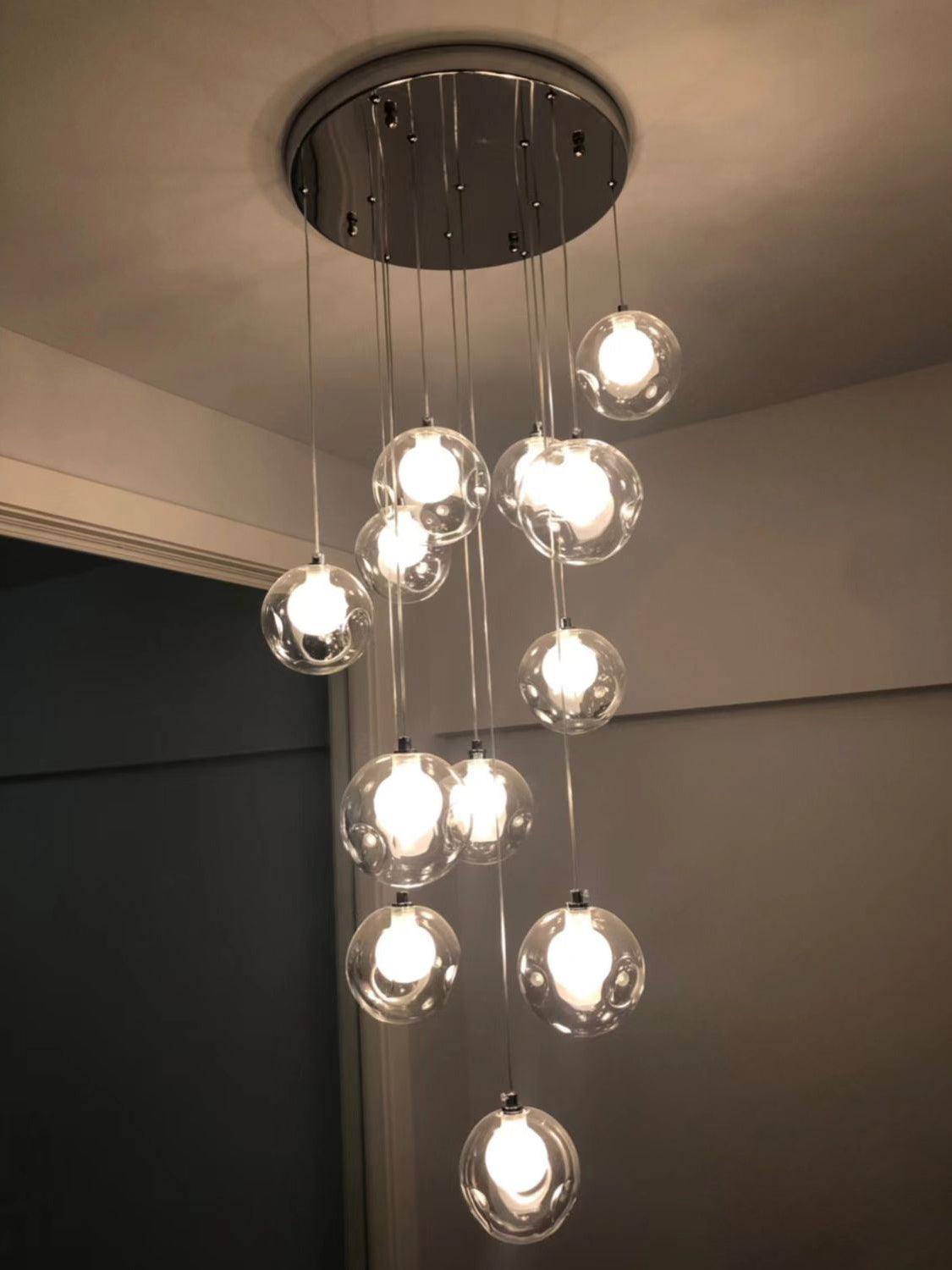 Clear glass globes below small round chrome canopy