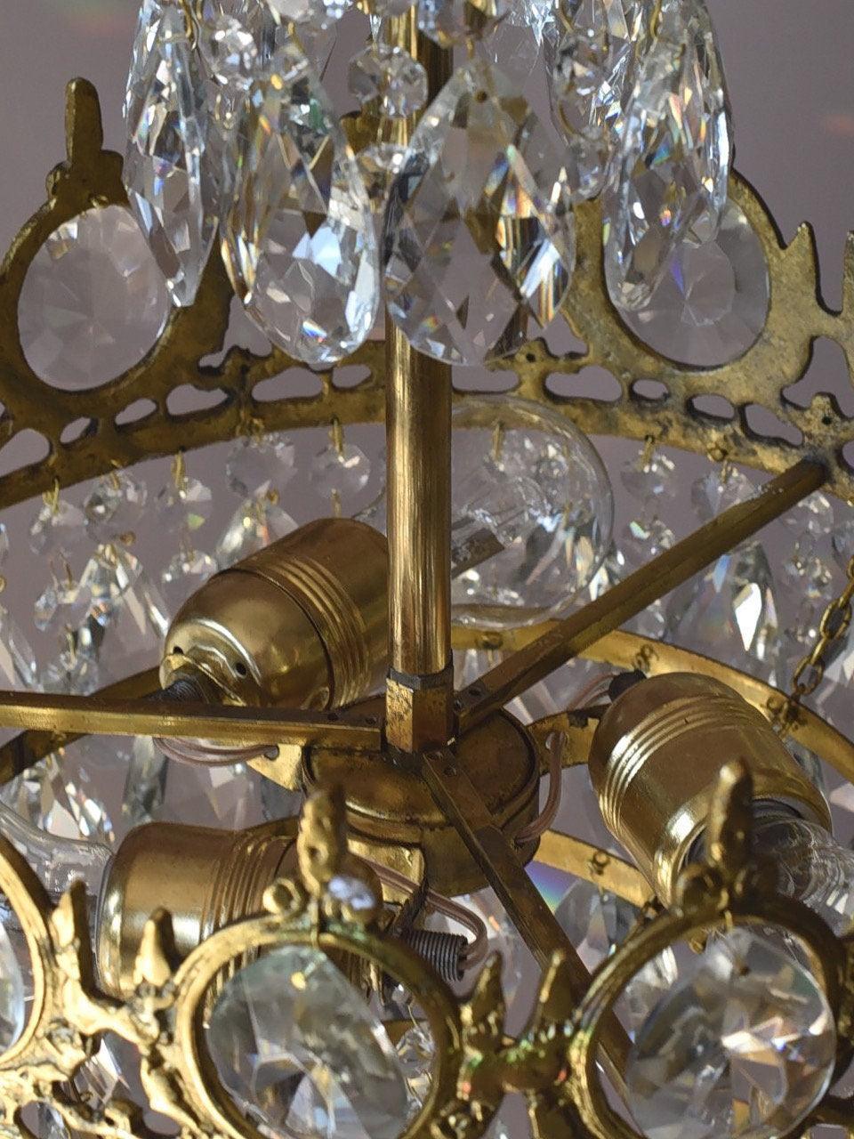 Chandelier interior showing a central stem, radial supports and bulb holders behind crystal drops